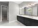 A large bathroom featuring double sinks, black cabinets, and a spacious walk-in shower at 1420 Coretta Bnd, Atlanta, GA 30318