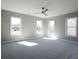 Bright bedroom featuring plush carpeting, four windows offering lots of natural light and a ceiling fan at 1420 Coretta Bend, Atlanta, GA 30318