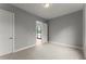 Bright bedroom features neutral carpet and paint, light fixture, and door to hall at 1420 Coretta Bnd, Atlanta, GA 30318
