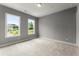 Bright bedroom with plush carpeting, neutral walls, and two windows offering ample natural light at 1420 Coretta Bnd, Atlanta, GA 30318