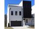 Modern two-story home featuring black trim, a gray garage door, and a neutral paint scheme at 1420 Coretta Bend, Atlanta, GA 30318