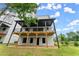 Townhome back exterior with covered deck and lower level entry to backyard at 1420 Coretta Bnd, Atlanta, GA 30318