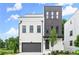 Modern exterior showcasing a two-story home with a painted brick facade, gray accents, and a two-car garage at 1420 Coretta Bnd, Atlanta, GA 30318