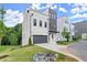 Modern two-story home with painted brick, gray accents, landscaping, driveway, and a well-manicured front lawn at 1420 Coretta Bnd, Atlanta, GA 30318