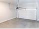 View of garage featuring a standard lift garage door, concrete floor, and white walls at 1420 Coretta Bend, Atlanta, GA 30318