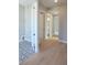 Hallway view of the laundry room with tile flooring, and a doorway to the bathroom at 1420 Coretta Bend, Atlanta, GA 30318