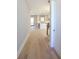 Inviting hallway with hardwood floors leading to an open-concept kitchen with white cabinets at 1420 Coretta Bend, Atlanta, GA 30318