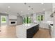 Modern kitchen with an island, quartz countertops, hardwood floors, and open to a living area with a fireplace at 1420 Coretta Bnd, Atlanta, GA 30318