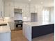Bright, airy kitchen with stainless steel appliances and an expansive island with a marbled countertop at 1420 Coretta Bend, Atlanta, GA 30318