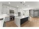 Modern kitchen features stainless steel appliances, a large island with quartz countertops, and hardwood floors at 1420 Coretta Bnd, Atlanta, GA 30318