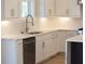 Modern kitchen with stainless steel dishwasher, white cabinets and countertops, and hardwood flooring at 1420 Coretta Bend, Atlanta, GA 30318