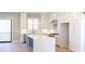 Bright, open kitchen boasts white cabinets, stainless steel appliances, and a large center island at 1420 Coretta Bend, Atlanta, GA 30318