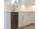 Modern kitchen with stainless steel dishwasher and white cabinets with contemporary hardware at 1420 Coretta Bend, Atlanta, GA 30318