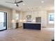 Open-concept kitchen featuring white cabinets, stainless steel appliances, a large island and wood floors at 1420 Coretta Bend, Atlanta, GA 30318
