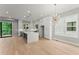 Spacious kitchen featuring white cabinetry, quartz countertops, stainless steel appliances, and light hardwood flooring at 1420 Coretta Bnd, Atlanta, GA 30318