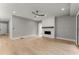 A spacious living room with a modern ceiling fan and stylish painted brick fireplace at 1420 Coretta Bnd, Atlanta, GA 30318