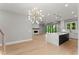 Open concept living space featuring an island kitchen, hardwood floors, fireplace, and access to the outdoor living at 1420 Coretta Bnd, Atlanta, GA 30318