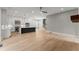 Open concept living room showcasing the kitchen, fireplace, and staircase. Modern and inviting! at 1420 Coretta Bnd, Atlanta, GA 30318