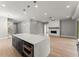 Open concept living space featuring an island kitchen, hardwood floors, fireplace, and modern light fixtures at 1420 Coretta Bnd, Atlanta, GA 30318