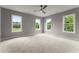 Expansive main bedroom with neutral carpeting, ceiling fan, and three large windows bringing in lots of natural light at 1420 Coretta Bnd, Atlanta, GA 30318