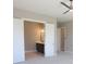 Main bedroom with ceiling fan, closet, and doorway to the bathroom with vanity and mirror at 1420 Coretta Bend, Atlanta, GA 30318