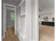 Mudroom with storage and bench leading to a view of the kitchen and living space at 1420 Coretta Bnd, Atlanta, GA 30318