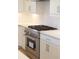 Modern kitchen with stainless steel range, white cabinets and countertops, and hardwood flooring at 1420 Coretta Bend, Atlanta, GA 30318