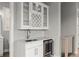 An interior wet bar featuring a beverage cooler, floating shelves, marble countertops and backsplash at 1420 Coretta Bnd, Atlanta, GA 30318