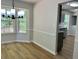 Dining area featuring wood floors, wainscoting and a modern chandelier at 3432 Sumter Pl, Decatur, GA 30034