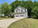 Charming home with a two-car garage, surrounded by lush greenery and a well-manicured lawn at 3432 Sumter Pl, Decatur, GA 30034