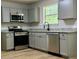 Updated kitchen with stainless steel appliances, granite countertops, and light gray cabinets at 3432 Sumter Pl, Decatur, GA 30034