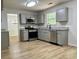 Modern kitchen features gray cabinets, stainless appliances, and wood-look flooring at 3432 Sumter Pl, Decatur, GA 30034