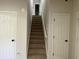 Carpeted staircase between two doorways in a home's interior at 3432 Sumter Pl, Decatur, GA 30034