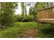 Backyard view from a wooden deck shows the property's wooded surroundings, perfect for nature lovers at 4215 Sherwood Ave, Decatur, GA 30035