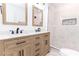 Modern bathroom with a double sink vanity, marble tile shower with a mosaic accent, and black hardware at 4215 Sherwood Ave, Decatur, GA 30035