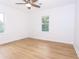 Bright bedroom features hardwood floors, a ceiling fan, and two windows that provide natural light at 4215 Sherwood Ave, Decatur, GA 30035