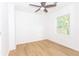 Bright bedroom with light wood flooring, white walls, two windows, and a ceiling fan at 4215 Sherwood Ave, Decatur, GA 30035