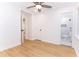 Bedroom featuring new floors, white walls, ceiling fan, and doorways to the hallway and the bathroom at 4215 Sherwood Ave, Decatur, GA 30035