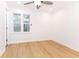 Bright bedroom featuring a ceiling fan, light wood flooring, and a window with natural light at 4215 Sherwood Ave, Decatur, GA 30035