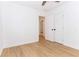 Bedroom features new wood flooring, fresh white paint, and a glimpse into the hallway at 4215 Sherwood Ave, Decatur, GA 30035