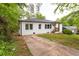 Home with a driveway and yard surrounded by mature trees at 4215 Sherwood Ave, Decatur, GA 30035