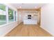 Sun-filled kitchen and dining area with island, white cabinets, and wood beam accent at 4215 Sherwood Ave, Decatur, GA 30035