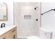 Bathroom featuring a walk-in shower with mosaic flooring, white marble tiling, and black hardware fixtures at 4215 Sherwood Ave, Decatur, GA 30035