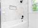 Modern bathroom with marble tiling in the shower and black hardware accents at 4215 Sherwood Ave, Decatur, GA 30035