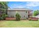 The exterior features a two-story screened porch, deck and spacious backyard shaded by mature trees at 732 Sweet Gum Way, Canton, GA 30115
