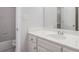 Traditional bathroom with white cabinets, single sink, and combined bath and shower at 732 Sweet Gum Way, Canton, GA 30115