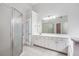 Bright bathroom featuring white tile floor, double vanity, and glass shower door at 732 Sweet Gum Way, Canton, GA 30115