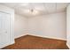 An empty bedroom with carpet and paneled ceiling with a double door closet at 732 Sweet Gum Way, Canton, GA 30115
