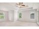 Bright bedroom with a tray ceiling, fan, and large windows bringing in natural light at 732 Sweet Gum Way, Canton, GA 30115