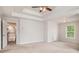 Spacious bedroom features tray ceilings, natural light, and doorway to hall with stairs at 732 Sweet Gum Way, Canton, GA 30115